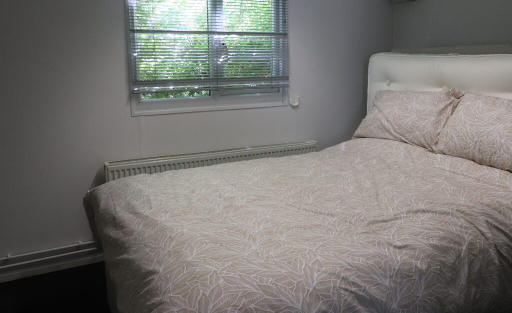 calm room with a double bed and cream bedding