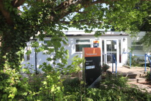 white building among green trees and bushes